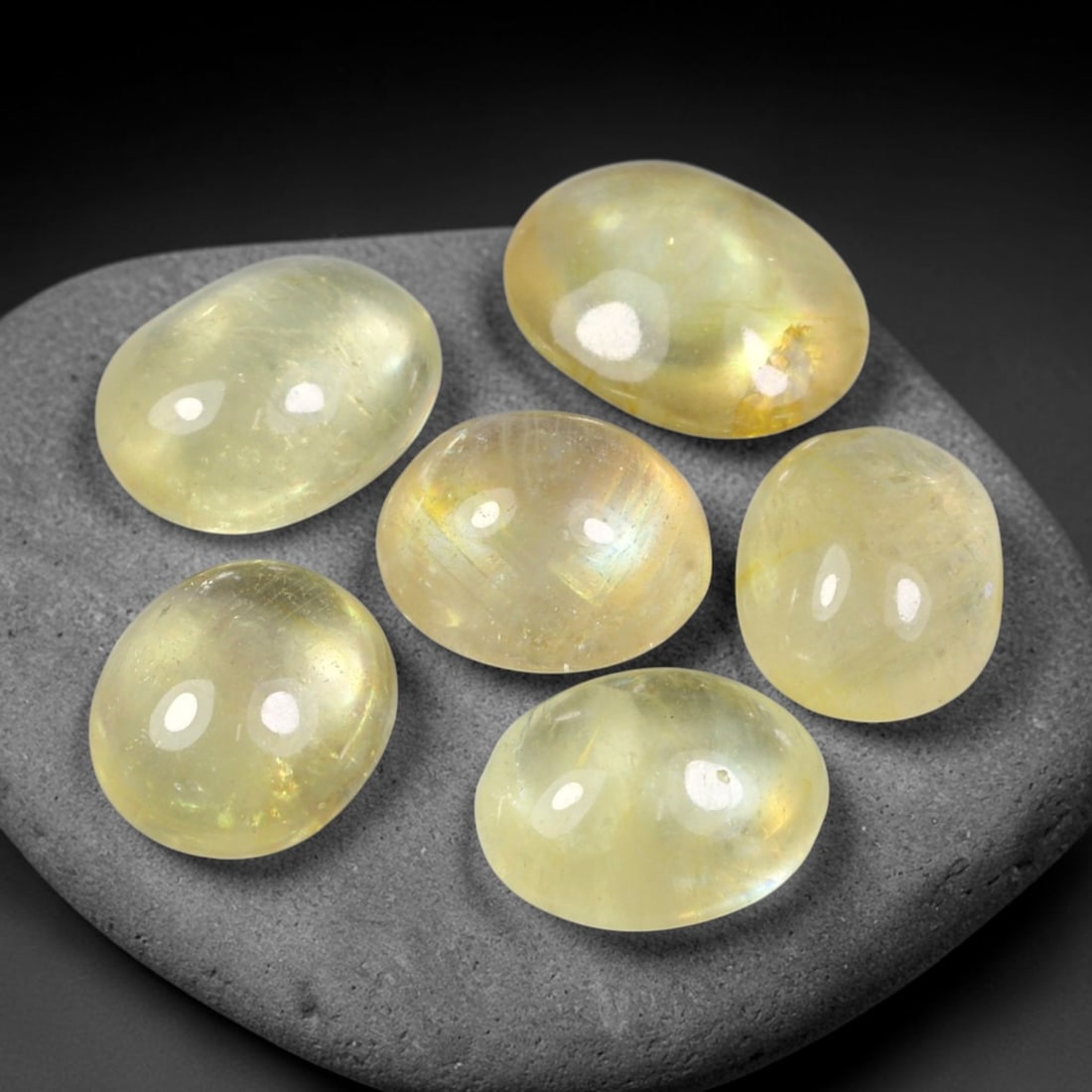 12.12ct Natural Yellow Sapphire Oval Cabochon Loose Gemstone Parcel, 67YW: This parcel oval cabochon natural yellow sapphires with each stone measuring 9.1x7.2x2.9mm. The gemstones display soft pale yellow colouration with natural internal inclusions; stones are fissure fill