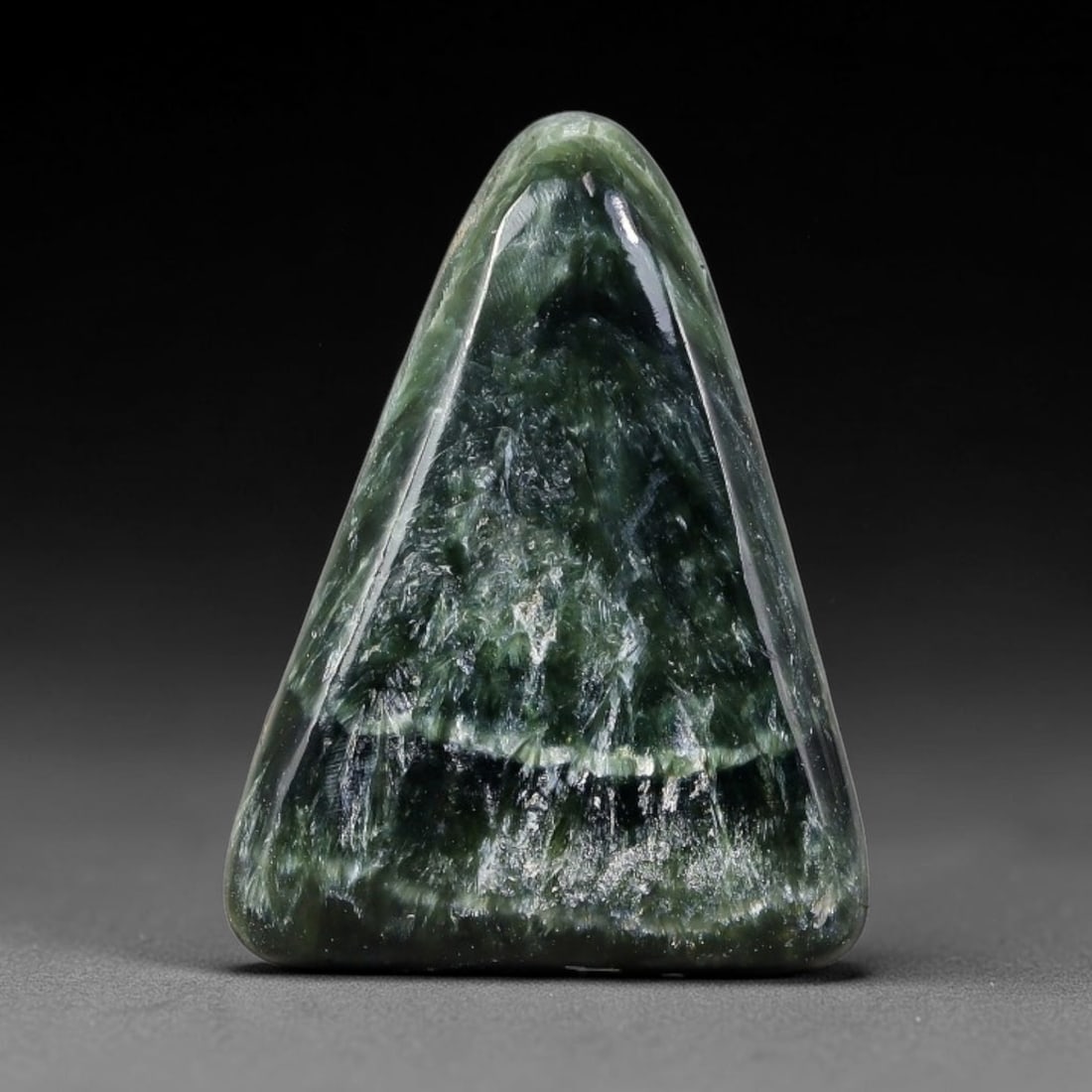 15.84 Carats Natural Deep Green Siberian Seraphinite Polished Cabochon, 41TZ: This is a fully natural polished seraphinite specimen sourced from Siberian deposits, displaying distinct feathery fibrous inclusions that create beautiful flowing chatoyant patterns across its smooth