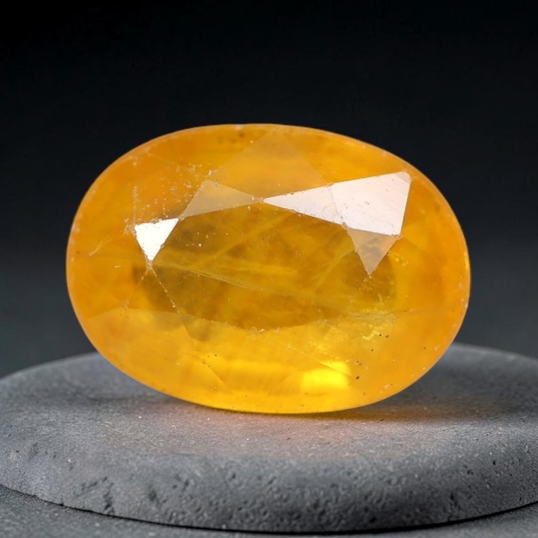 0.98 Carats Natural Yellow Sapphire Oval Faceted Loose Gemstone, 68TT: This natural yellow sapphire features a classic oval brilliant faceted cut, holding consistent warm golden-yellow color throughout the corundum crystal. Fine microscopic mineral specks and faint natur