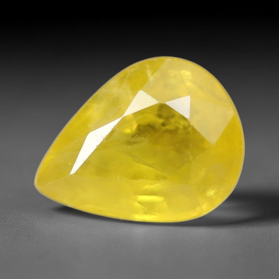 1.27 Carats Natural Yellow Sapphire Pear Faceted Loose Gemstone, 48TT: This natural yellow sapphire features a classic Pear brilliant faceted cut, holding consistent warm golden-yellow color throughout the corundum crystal. Fine microscopic mineral specks and faint natur