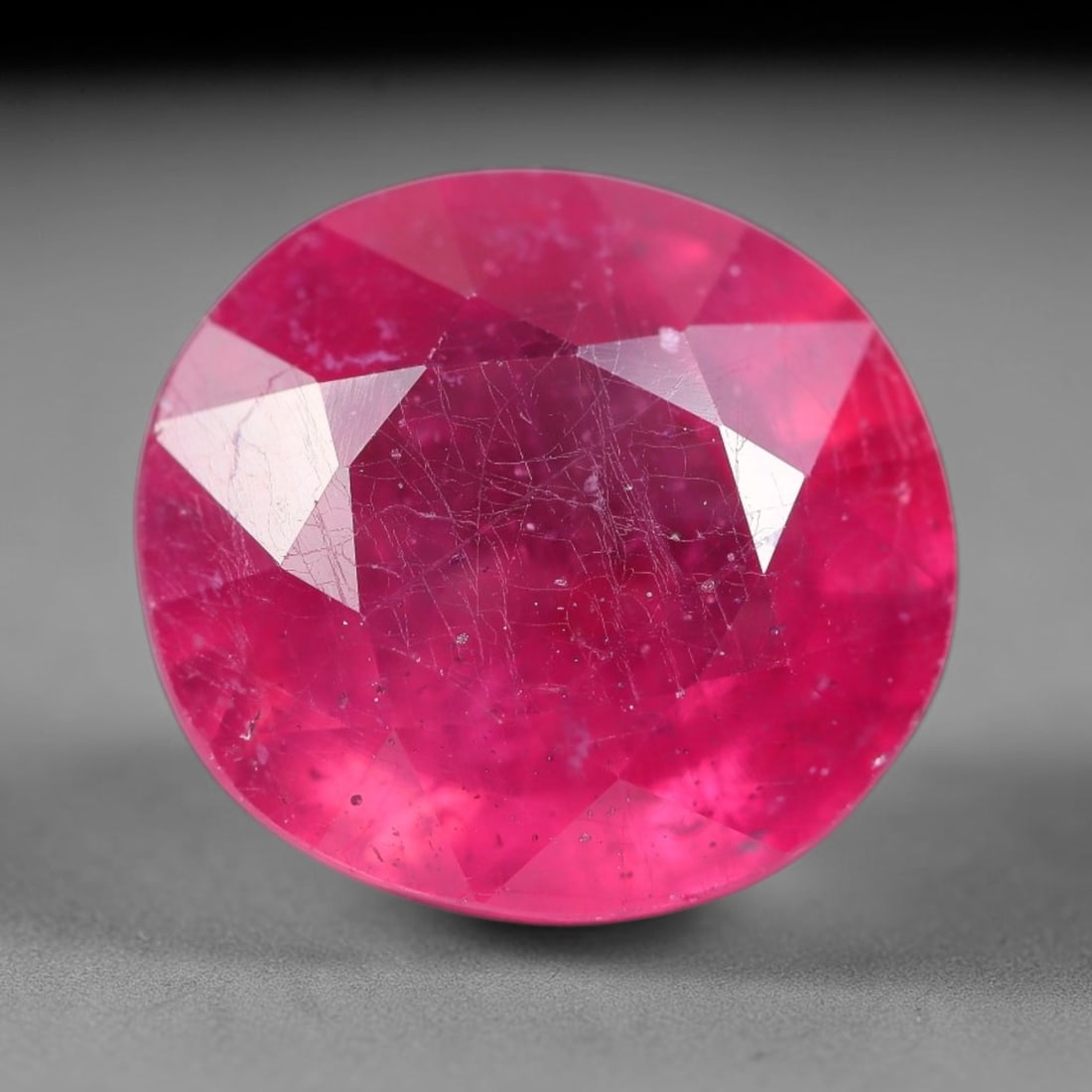 8.63 Carats Natural Mozambique Ruby Oval Faceted Loose Gemstone, 11SA: This natural Mozambique ruby is fashioned with standard oval brilliant faceting, displaying vivid saturated crimson-red hue accompanied by native fine mineral inclusions and subtle trace marks inheren
