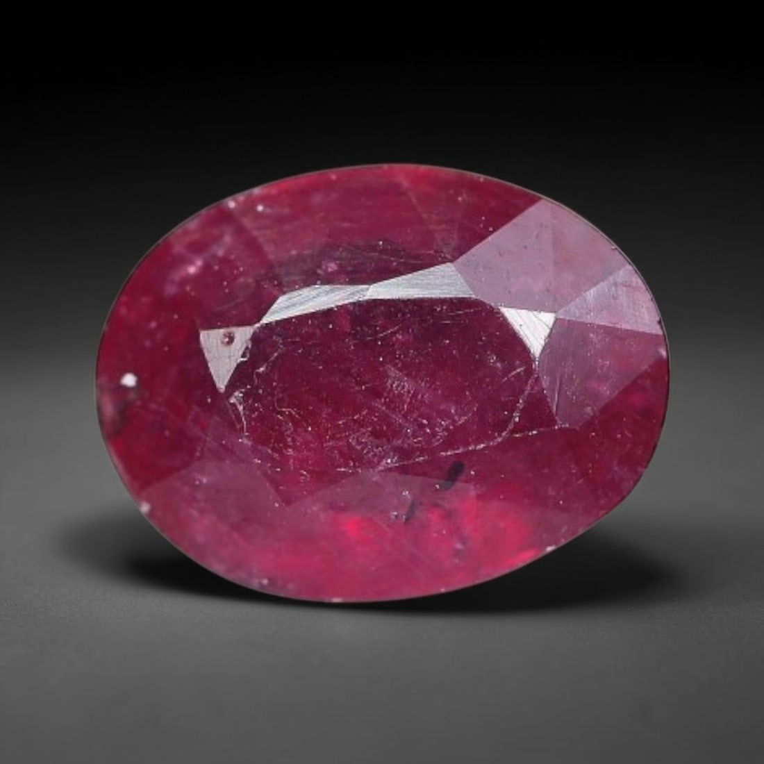 1.91 Carats Natural Mozambique Ruby Oval Faceted Loose Gemstone, 69TY: This natural Mozambique ruby is fashioned with standard oval brilliant faceting, displaying vivid saturated crimson-red hue accompanied by native fine mineral inclusions and subtle trace marks inheren