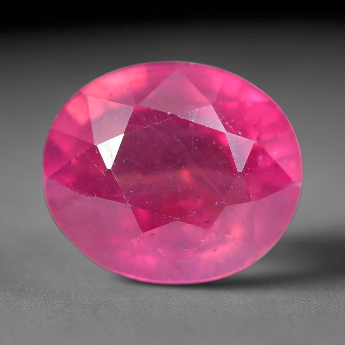 6.92 Carats Natural Mozambique Ruby Oval Faceted Loose Gemstone, 30SA: This natural Mozambique ruby is fashioned with standard oval brilliant faceting, displaying vivid saturated crimson-red hue accompanied by native fine mineral inclusions and subtle trace marks inheren