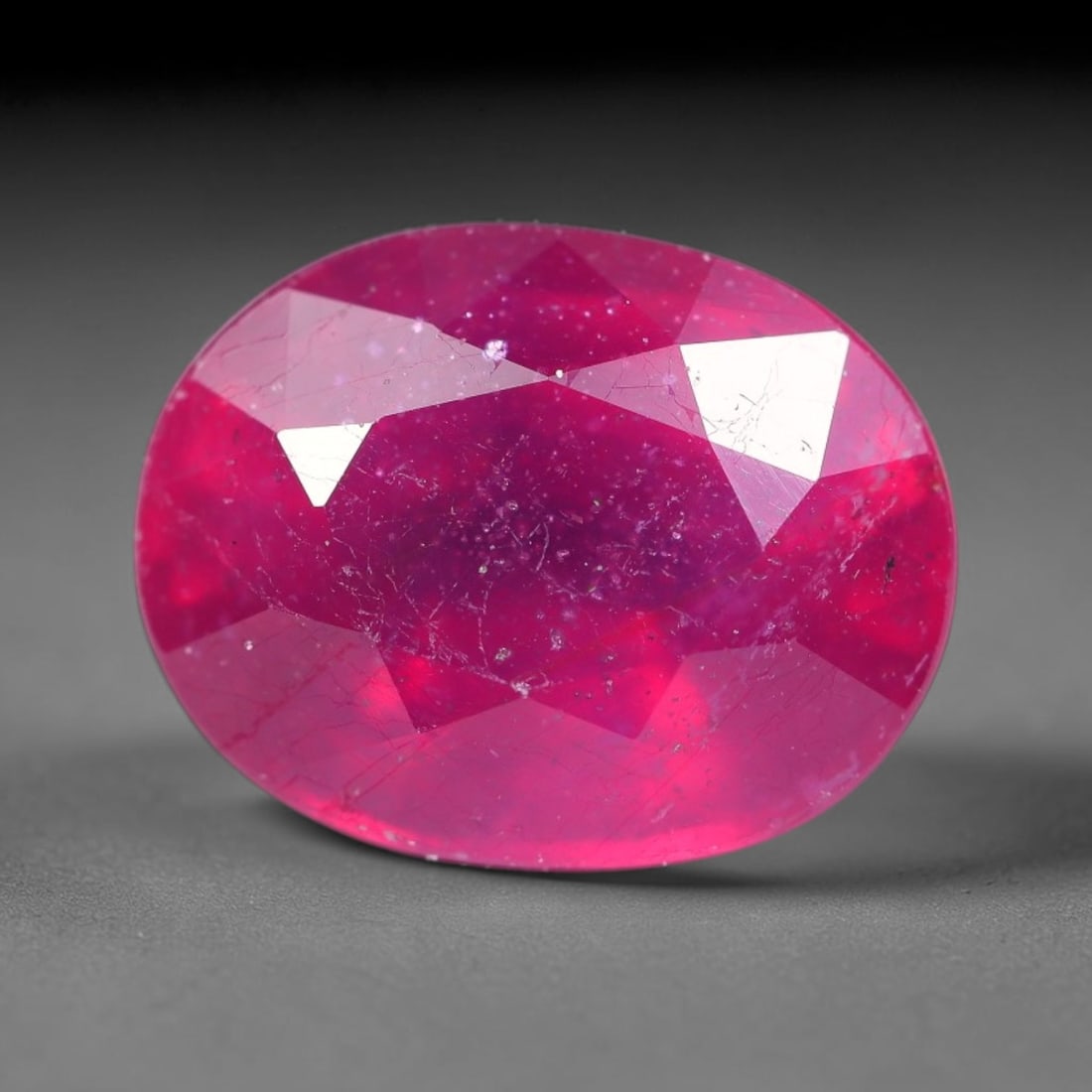 6.89 Carats Natural Mozambique Ruby Oval Faceted Loose Gemstone, 14SA: This natural Mozambique ruby is fashioned with standard oval brilliant faceting, displaying vivid saturated crimson-red hue accompanied by native fine mineral inclusions and subtle trace marks inheren