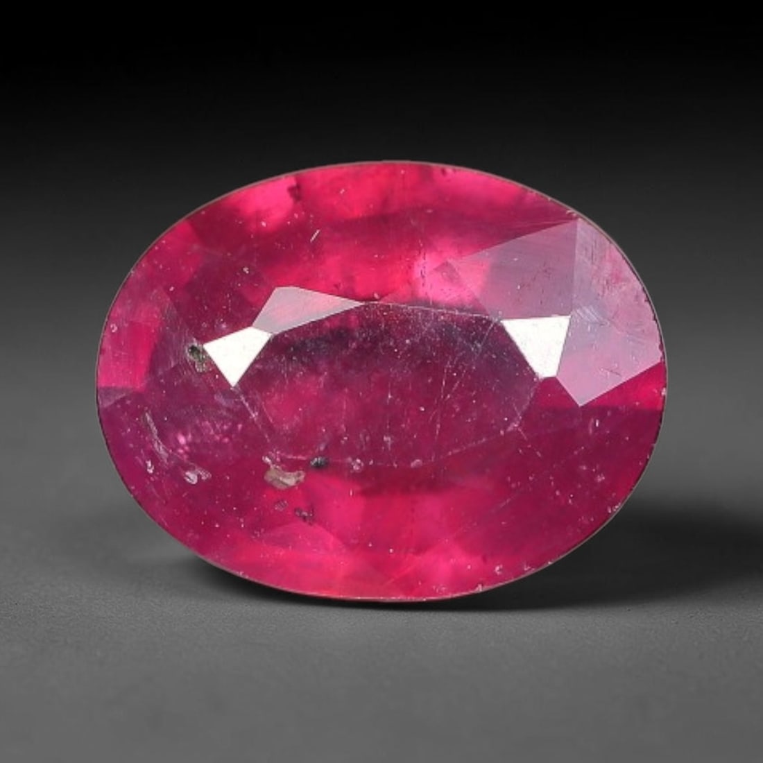 1.51 Carats Natural Mozambique Ruby Oval Faceted Loose Gemstone, 77TY: This natural Mozambique ruby is fashioned with standard oval brilliant faceting, displaying vivid saturated crimson-red hue accompanied by native fine mineral inclusions and subtle trace marks inheren