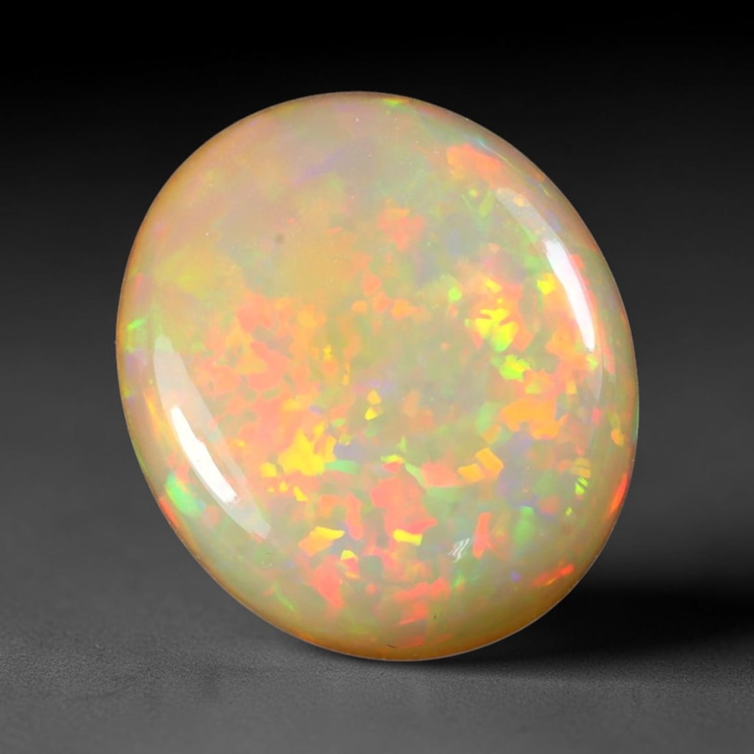 8.84ct Natural Multicolor Fire Ethiopian Welo Solid Opal Cabochon, 65TY: Formed from natural silica deposits within Ethiopian mineral veins, this solid opal cabochon is polished to a smooth domed surface that reveals inherent light diffraction properties. Vibrant patchwork