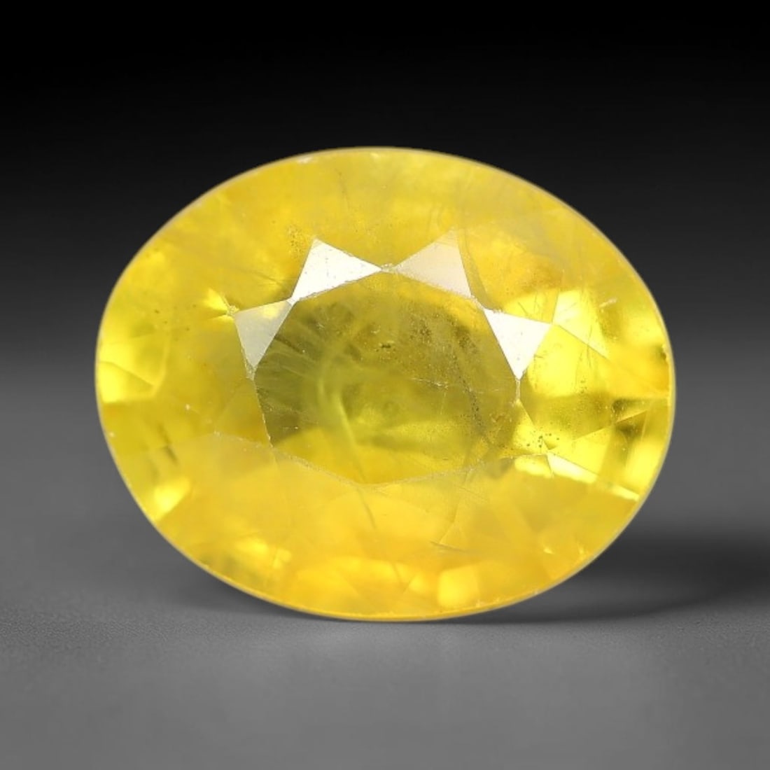 2.46 Carats Natural Yellow Sapphire Oval Faceted Loose Gemstone, 19TT: This natural yellow sapphire features a classic oval brilliant faceted cut, holding consistent warm golden-yellow color throughout the corundum crystal. Fine microscopic mineral specks and faint natur