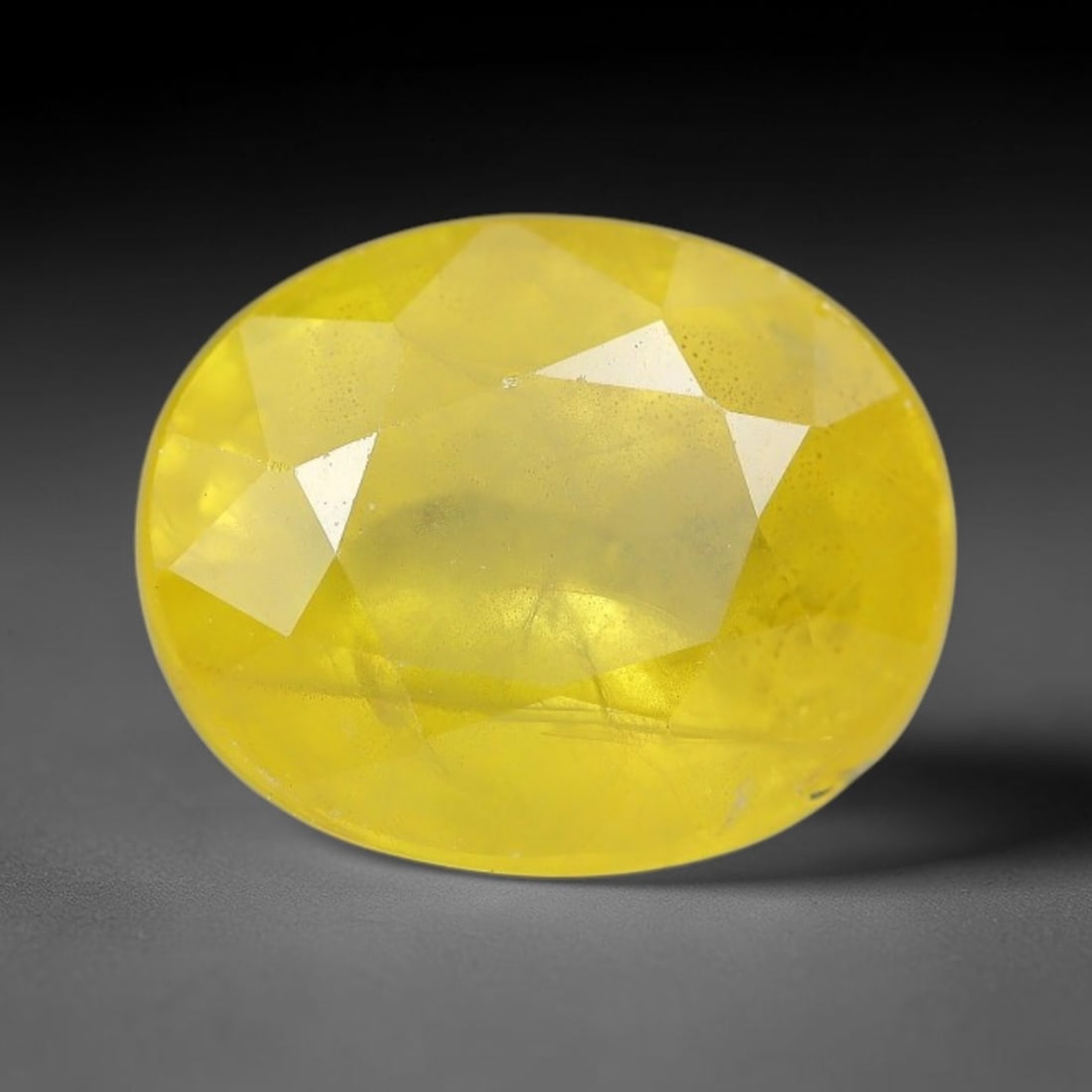 3.48 Carats Natural Yellow Sapphire Oval Faceted Loose Gemstone, 27TT: This natural yellow sapphire features a classic oval brilliant faceted cut, holding consistent warm golden-yellow color throughout the corundum crystal. Fine microscopic mineral specks and faint natur