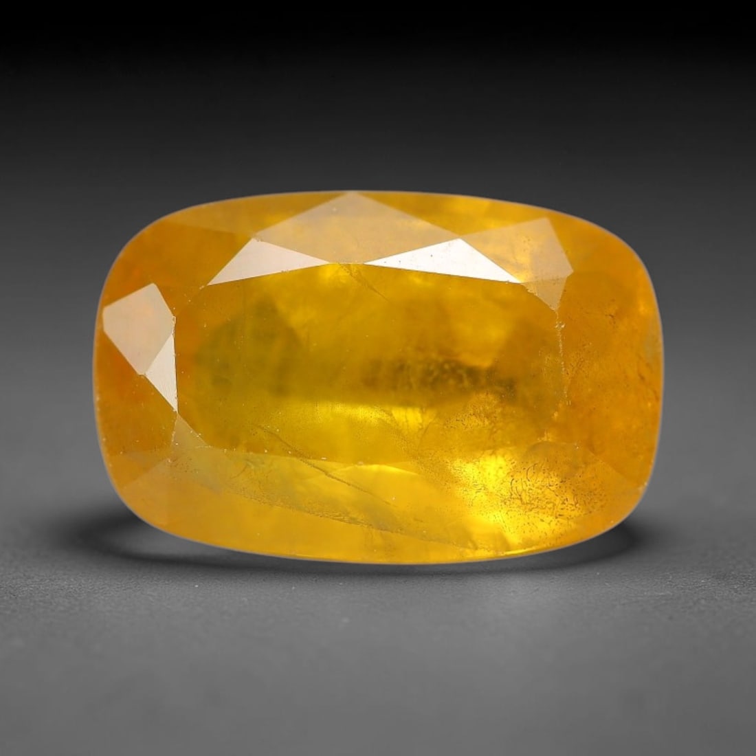 4.58 Carats Natural Yellow Sapphire Oval Faceted Loose Gemstone, 35TT: This natural yellow sapphire features a classic oval brilliant faceted cut, holding consistent warm golden-yellow color throughout the corundum crystal. Fine microscopic mineral specks and faint natur
