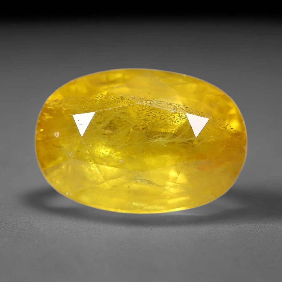 3.22 Carats Natural Yellow Sapphire Oval Faceted Loose Gemstone, 23TT: This natural yellow sapphire features a classic oval brilliant faceted cut, holding consistent warm golden-yellow color throughout the corundum crystal. Fine microscopic mineral specks and faint natur