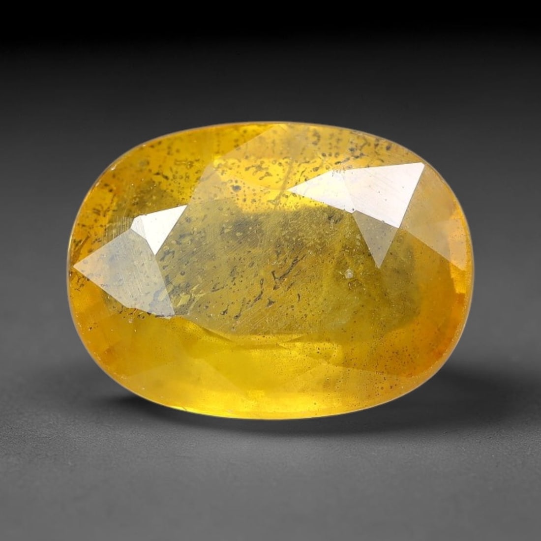 2.25 Carats Natural Yellow Sapphire Oval Faceted Loose Gemstone, 14TT: This natural yellow sapphire features a classic oval brilliant faceted cut, holding consistent warm golden-yellow color throughout the corundum crystal. Fine microscopic mineral specks and faint natur