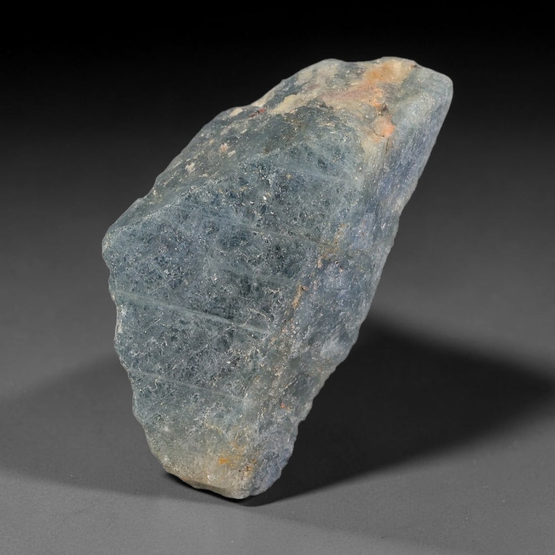 99.73ct Natural Blue Sapphire Rough Specimen, 94TV: Natural blue sapphire rough crystal specimen, measuring 38.2x19.8x11.4mm, weight 99.73 carats. Features soft blue tones with natural mineral inclusions and surface textures from geological formation. 
