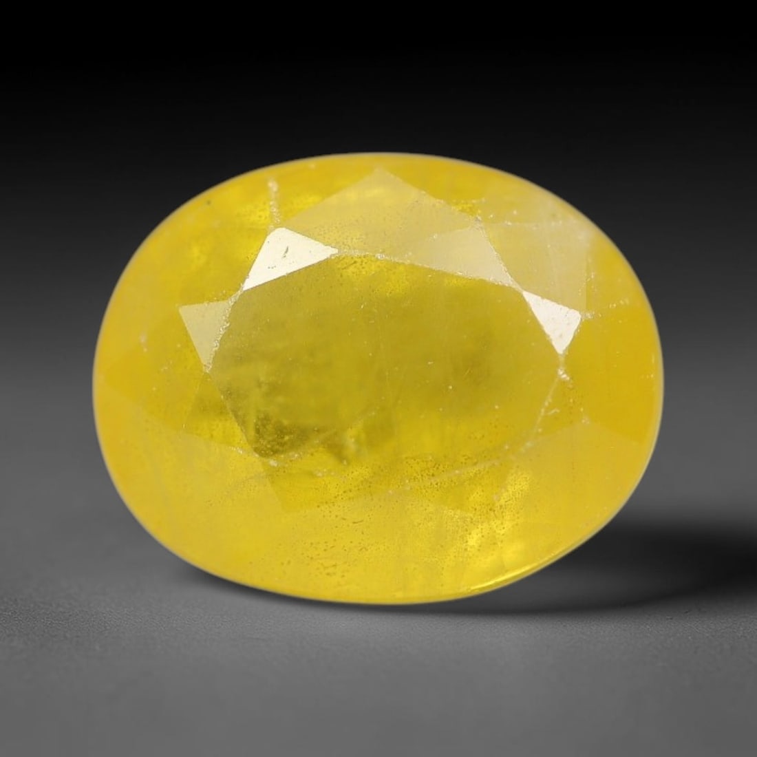 3.89 Carats Natural Yellow Sapphire Oval Faceted Loose Gemstone, 28TT: This natural yellow sapphire features a classic oval brilliant faceted cut, holding consistent warm golden-yellow color throughout the corundum crystal. Fine microscopic mineral specks and faint natur