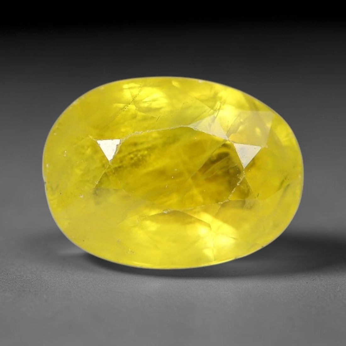 2.23 Carats Natural Yellow Sapphire Oval Faceted Loose Gemstone, 12TT: This natural yellow sapphire features a classic oval brilliant faceted cut, holding consistent warm golden-yellow color throughout the corundum crystal. Fine microscopic mineral specks and faint natur