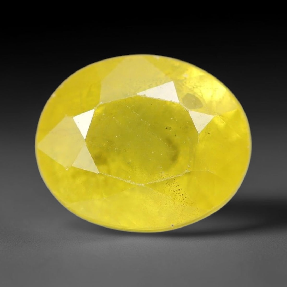 3.40 Carats Natural Yellow Sapphire Oval Faceted Loose Gemstone, 36TT: This natural yellow sapphire features a classic oval brilliant faceted cut, holding consistent warm golden-yellow color throughout the corundum crystal. Fine microscopic mineral specks and faint natur