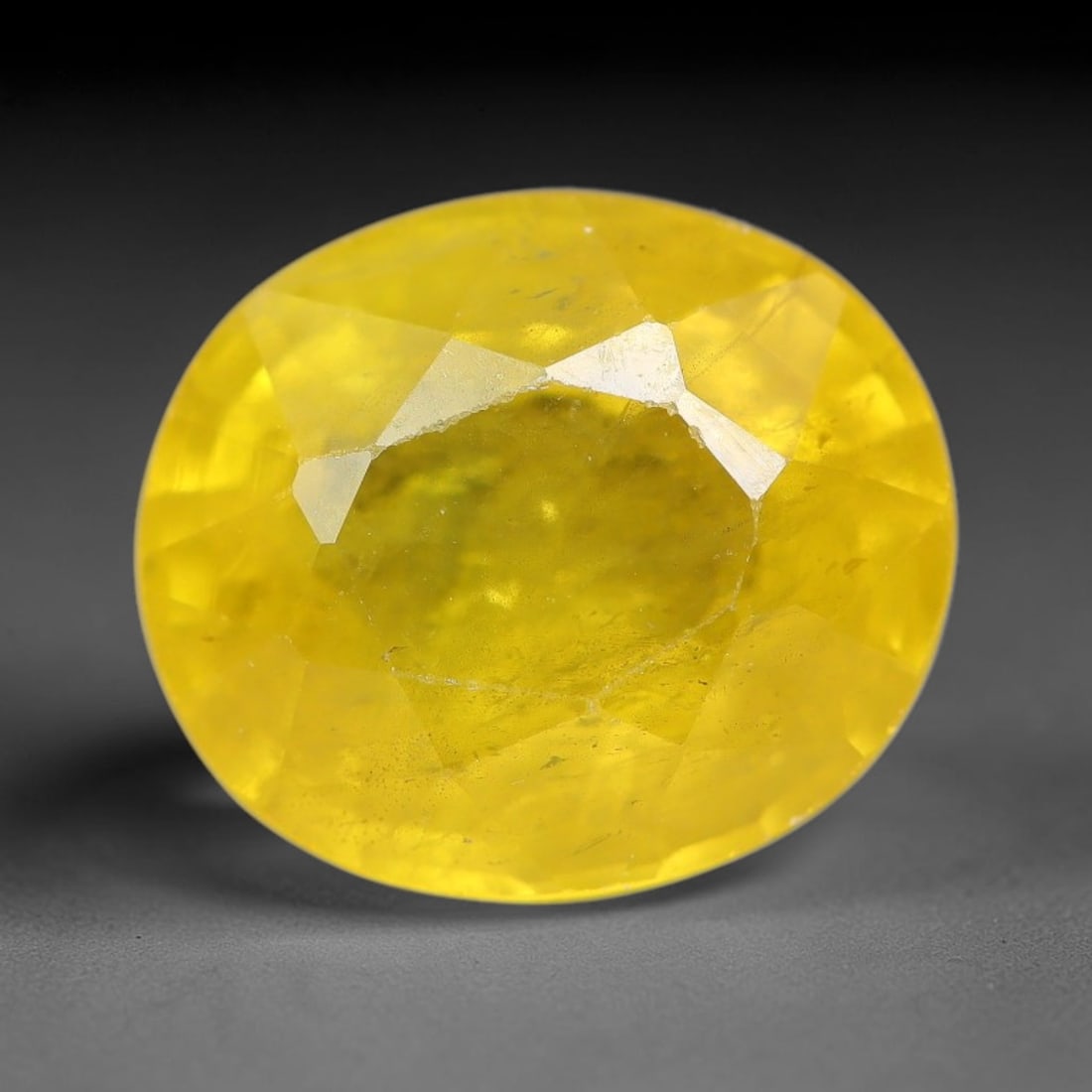 2.22 Carats Natural Yellow Sapphire Oval Faceted Loose Gemstone, 86TT: This natural yellow sapphire features a classic oval brilliant faceted cut, holding consistent warm golden-yellow color throughout the corundum crystal. Fine microscopic mineral specks and faint natur