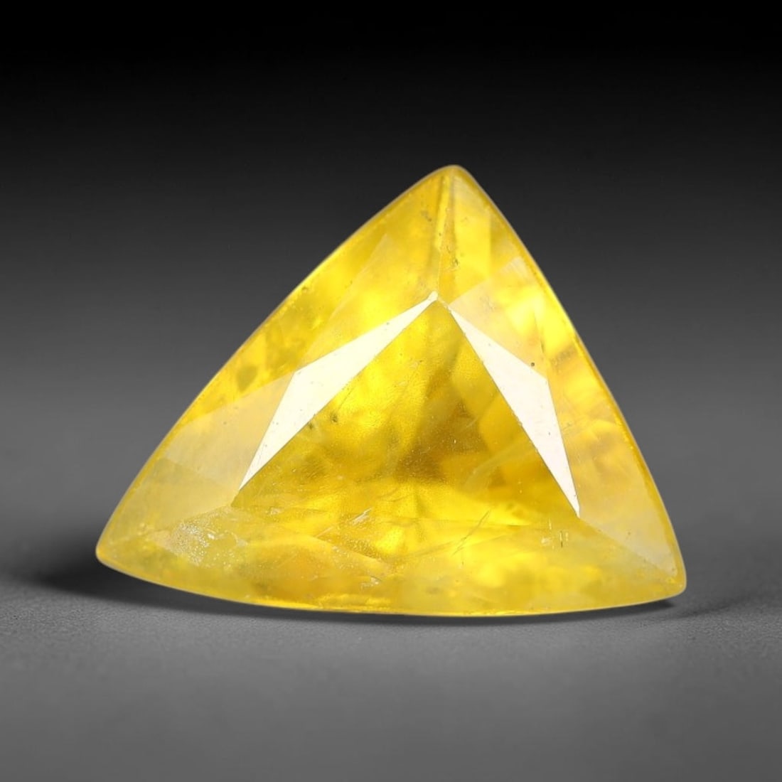 2.25 Carats Natural Yellow Sapphire Triangle Faceted Loose Gemstone, 13TT: This natural yellow sapphire features a classic triangle brilliant faceted cut, holding consistent warm golden-yellow color throughout the corundum crystal. Fine microscopic mineral specks and faint n