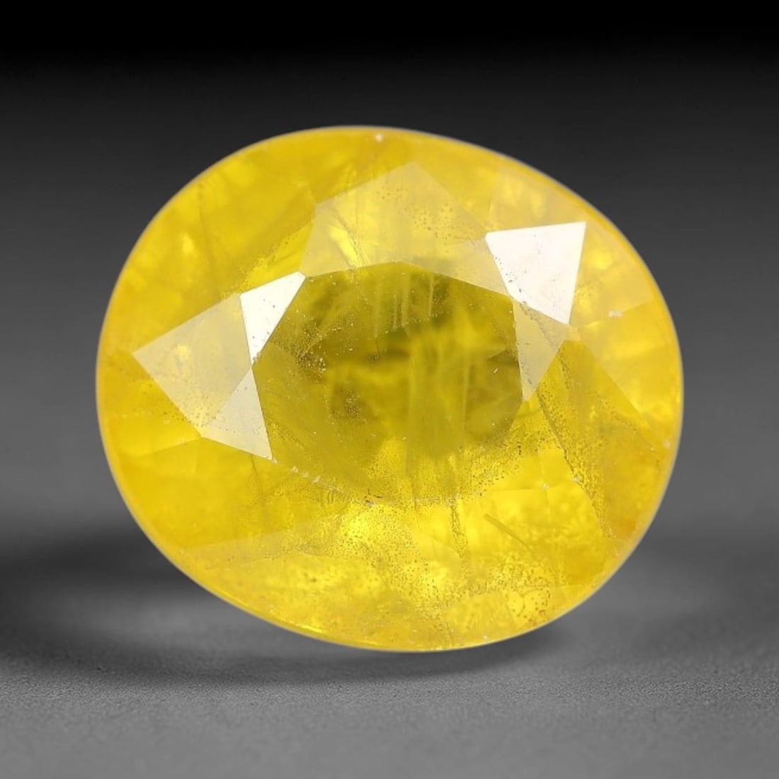 3.79 Carats Natural Yellow Sapphire Oval Faceted Loose Gemstone, 24TT: This natural yellow sapphire features a classic oval brilliant faceted cut, holding consistent warm golden-yellow color throughout the corundum crystal. Fine microscopic mineral specks and faint natur