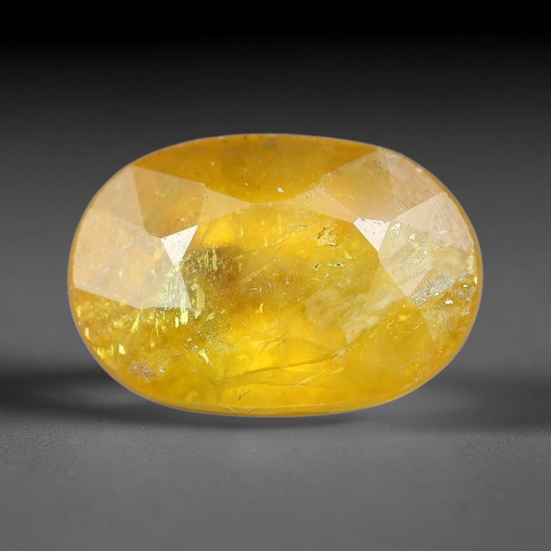 3.73 Carats Natural Yellow Sapphire Oval Faceted Loose Gemstone, 38TT: This natural yellow sapphire features a classic oval brilliant faceted cut, holding consistent warm golden-yellow color throughout the corundum crystal. Fine microscopic mineral specks and faint natur