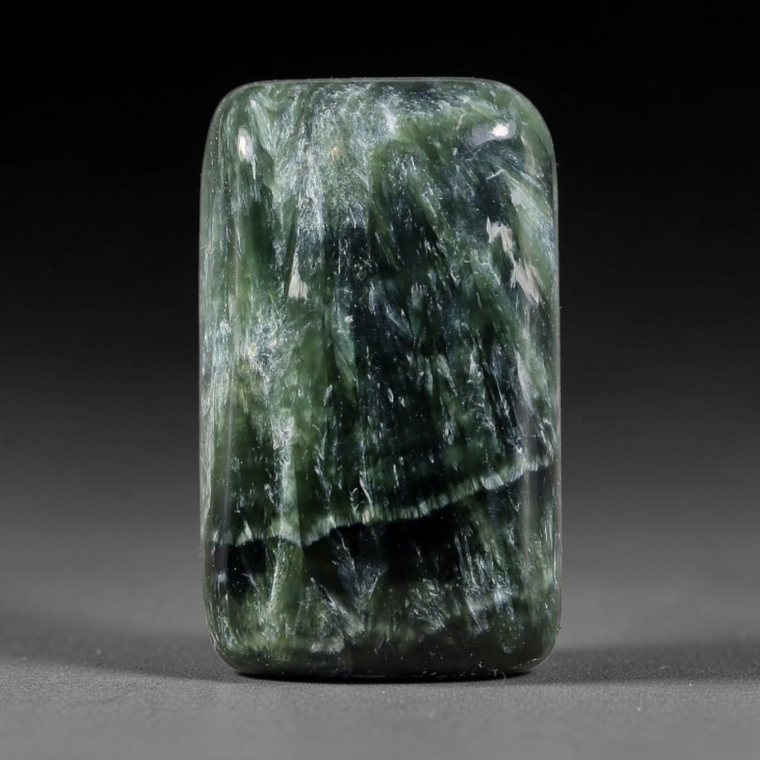15.55 Carats Natural Deep Green Siberian Seraphinite Polished Cabochon, 37TZ: This is a fully natural polished seraphinite specimen sourced from Siberian deposits, displaying distinct feathery fibrous inclusions that create beautiful flowing chatoyant patterns across its smooth