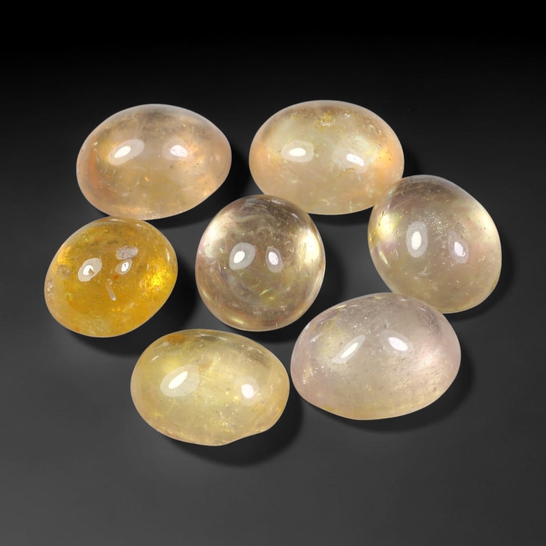 19.45ct Natural Yellow Sapphire Oval Cabochon Loose Gemstone Parcel, 64YW: This parcel oval cabochon natural yellow sapphires with each stone measuring 9.3x7.4x4.9mm. The gemstones display soft pale yellow colouration with natural internal inclusions; stones are fissure fill