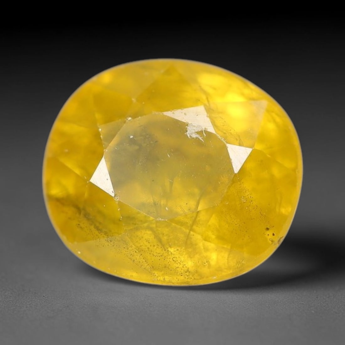 2.94 Carats Natural Yellow Sapphire Oval Faceted Loose Gemstone, 34TT: This natural yellow sapphire features a classic oval brilliant faceted cut, holding consistent warm golden-yellow color throughout the corundum crystal. Fine microscopic mineral specks and faint natur
