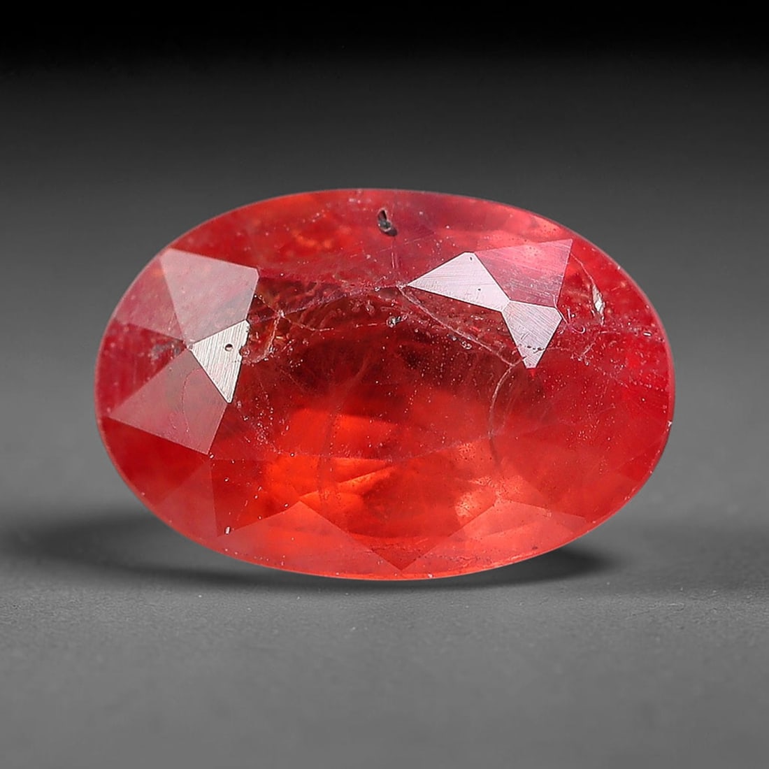 0.76 Carats Natural Orange Sapphire Oval Faceted Loose Gemstone, 84YW: This natural orange sapphire is fashioned in a classic oval brilliant faceted cut, presenting soft warm orange hues consistent with natural corundum specimens. Fine scattered mineral specks and faint 