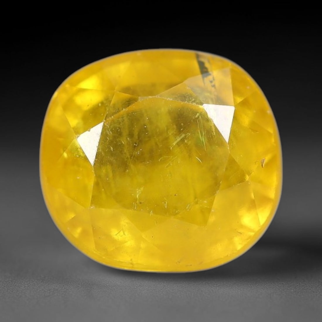3.03 Carats Natural Yellow Sapphire Oval Faceted Loose Gemstone, 32TT: This natural yellow sapphire features a classic oval brilliant faceted cut, holding consistent warm golden-yellow color throughout the corundum crystal. Fine microscopic mineral specks and faint natur