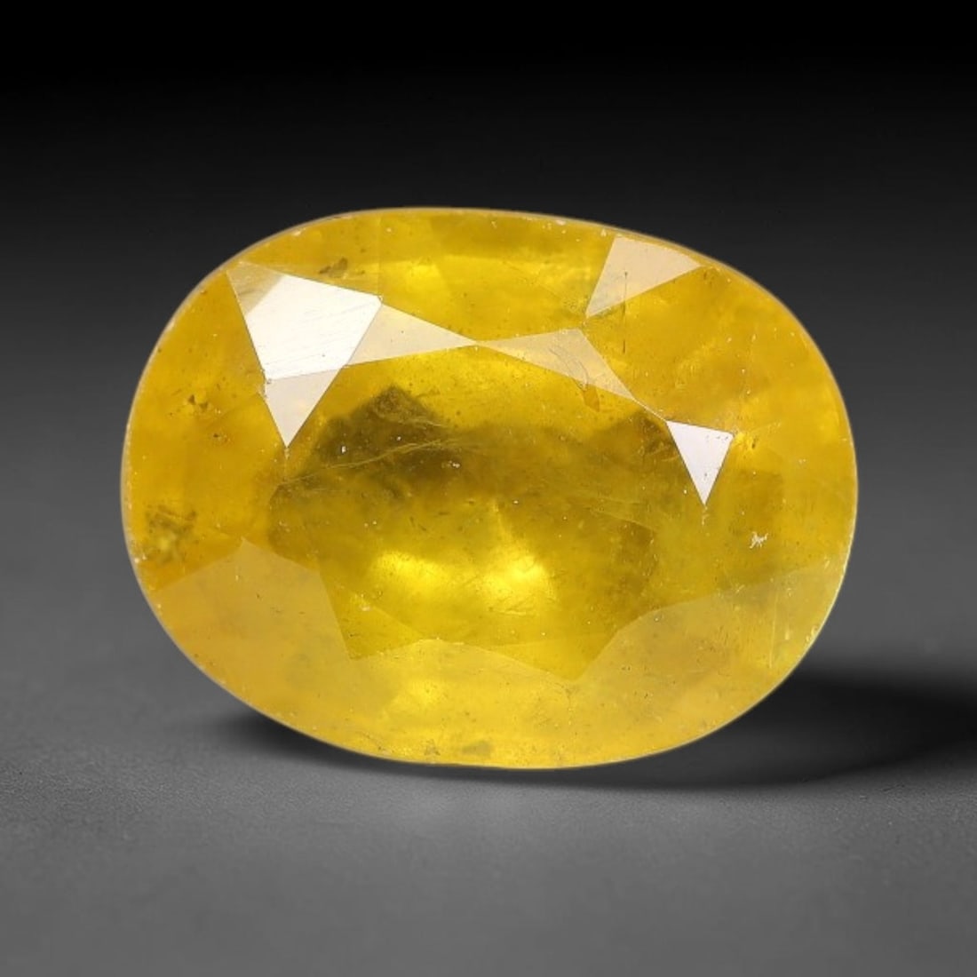 2.18 Carats Natural Yellow Sapphire Oval Faceted Loose Gemstone, 18TT: This natural yellow sapphire features a classic oval brilliant faceted cut, holding consistent warm golden-yellow color throughout the corundum crystal. Fine microscopic mineral specks and faint natur