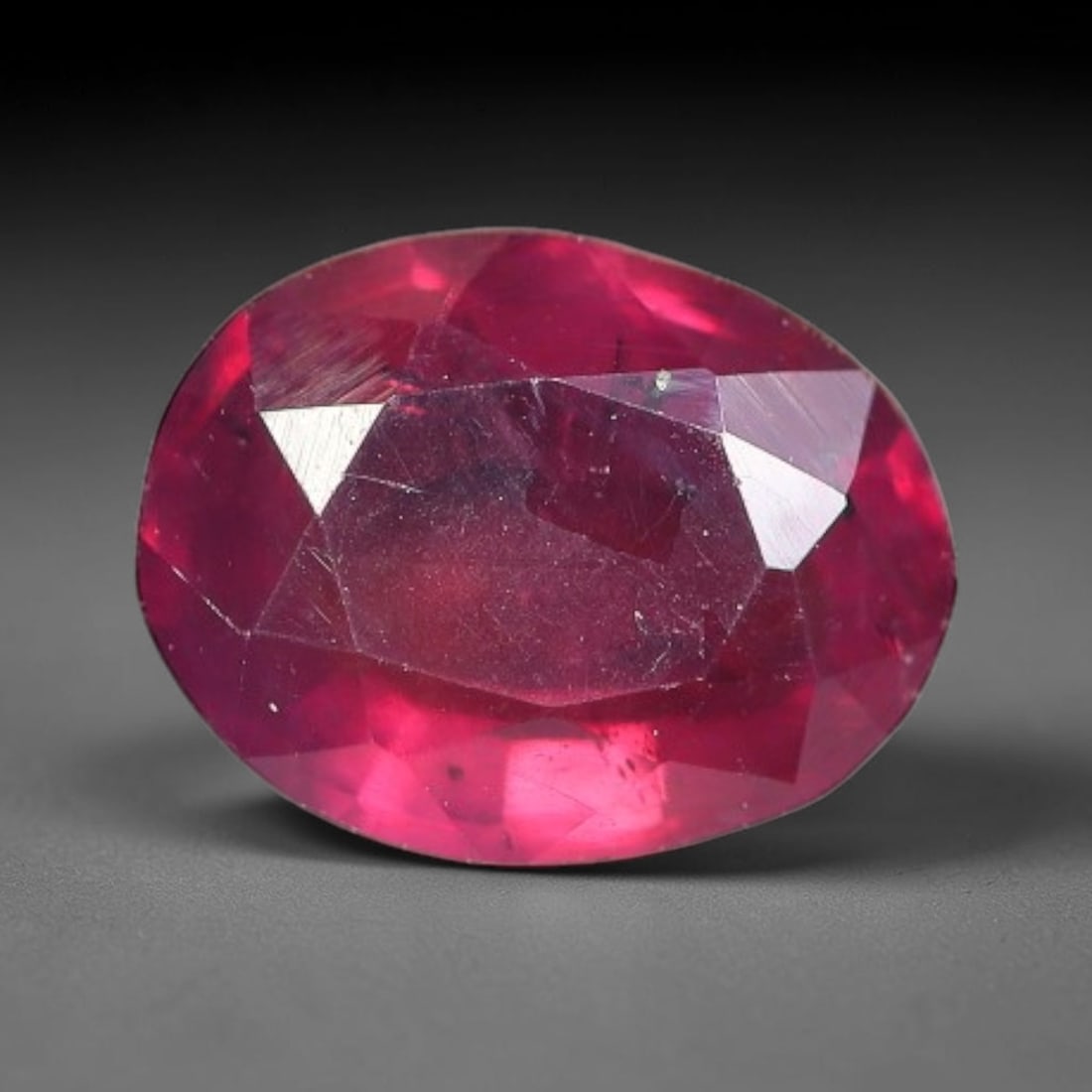 1.46 Carats Natural Mozambique Ruby Oval Faceted Loose Gemstone, 73TY: This natural Mozambique ruby is fashioned with standard oval brilliant faceting, displaying vivid saturated crimson-red hue accompanied by native fine mineral inclusions and subtle trace marks inheren