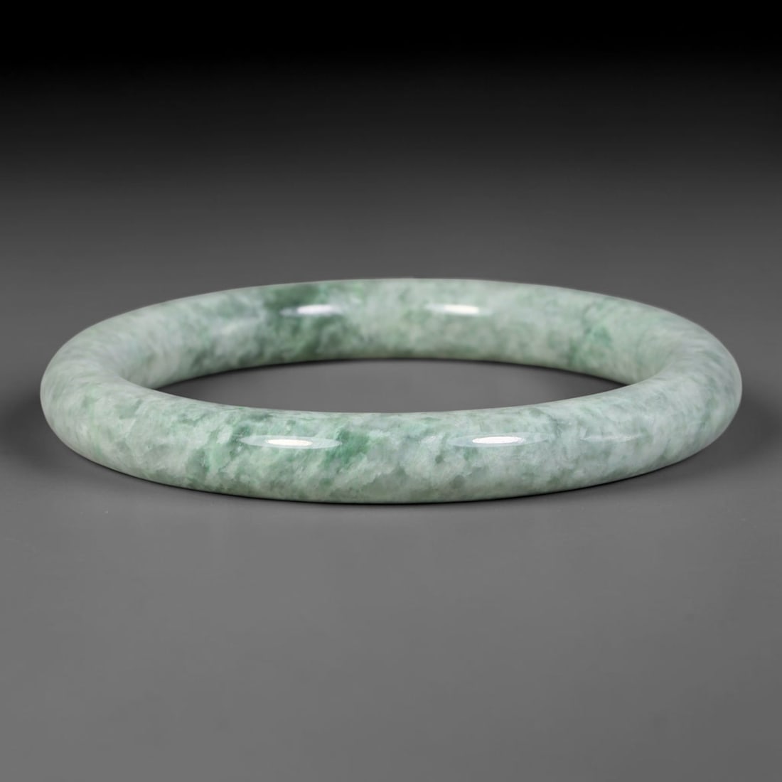 Natural Burmese Type A Variegated Floating Green Jadeite Jade Slim Bangle Bracelet, 10TJ: Polished slim jadeite bangle with soft pale mint base covered in blended variegated floating green cloud mottling. Inner dimension 53.6x8.7mm, thin rounded band with smooth natural gloss. Soft diffuse
