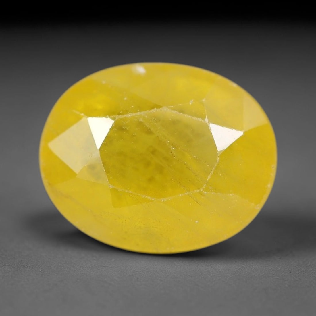 3.95 Carats Natural Yellow Sapphire Oval Faceted Loose Gemstone, 31TT: This natural yellow sapphire features a classic oval brilliant faceted cut, holding consistent warm golden-yellow color throughout the corundum crystal. Fine microscopic mineral specks and faint natur