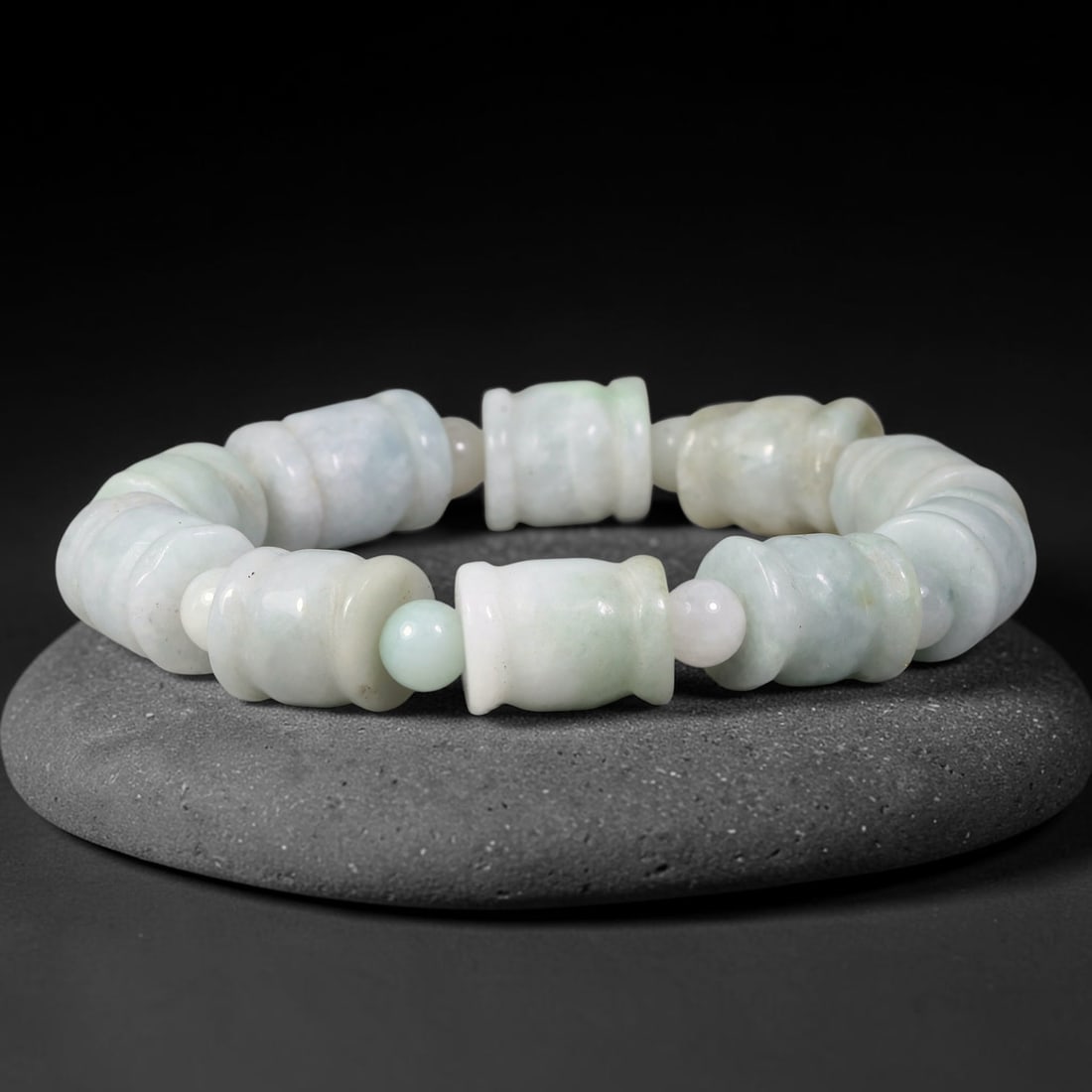 Natural Burmese Type A Carved Barrel Jadeite Jade Bracelet, 52TK: Hand-strung bracelet featuring carved barrel-shaped natural Burmese Type A jadeite beads measuring 11.7mm. The beads display soft pale celadon and milky white tones with faint natural mottling. Small 