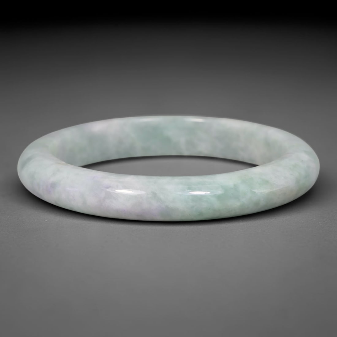 Natural Burmese Type A Pale Lavender Mottled Green Jadeite Jade Bangle Bracelet, 31TD: This slender band bangle is crafted from natural Burmese Type A jadeite. The stone features a soft pale lavender base blended with diffused muted light green mottling across the whole surface. The ban