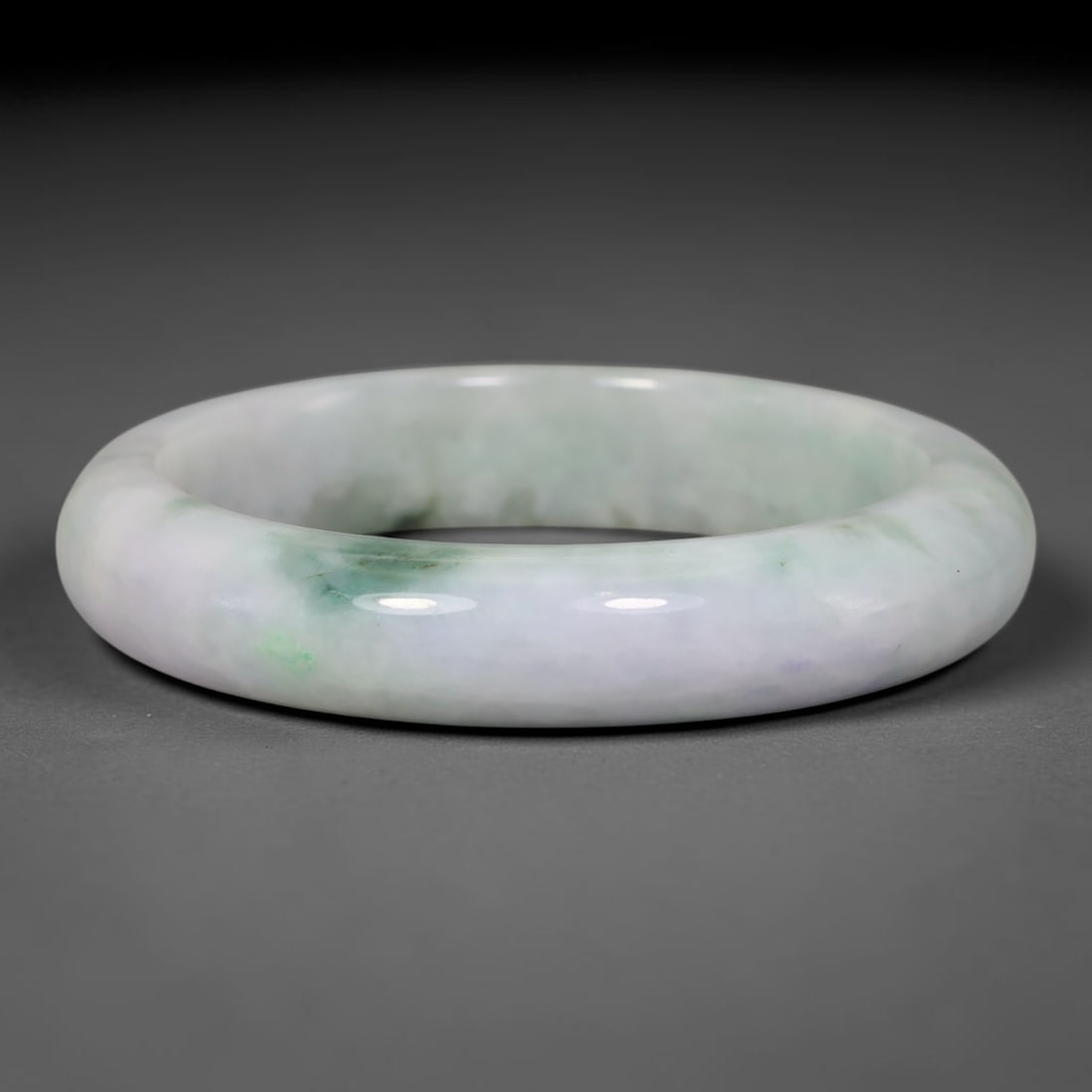 Natural Burmese Type A Pale Lavender Floating Green Jadeite Jade Bangle Bracelet, 23TD: This thick band bangle is crafted from natural Burmese Type A jadeite. The stone features a pale milky lavender base with soft, diffused floating green clouding concentrated in gentle patches across t