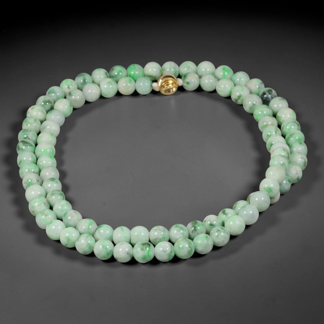 Natural Burmese Type A Floating Green Jadeite Jade Beaded Necklace, 28TF: This necklace is crafted from smoothly polished round natural Burmese Type A jadeite beads of 7.2mm, featuring a pale milky base decorated with vibrant floating green mottling across the bead surfaces