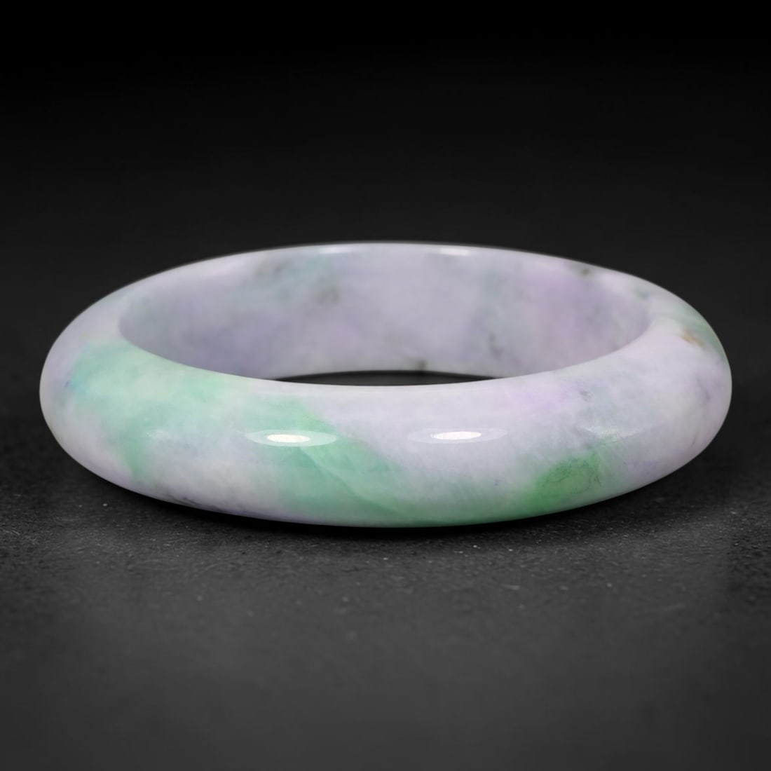 Natural Burmese Type A Lavender Floating Green Jadeite Jade Bangle Bracelet, 34TD: This wide band bangle is formed from natural Burmese Type A jadeite. The stone features a soft pale lavender base with flowing patches of vibrant floating green, forming a natural blended colour trans