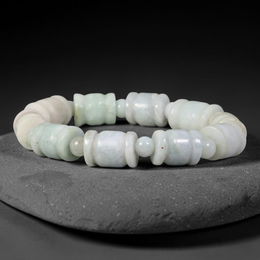 Natural Burmese Type A Barrel Shaped Jadeite Jade Bracelet, 53TK: This bracelet is hand-strung with carved barrel-shaped natural Burmese Type A jadeite beads measuring 11.7mm. The beads feature soft pale celadon and milky white tones with subtle natural mottling. Sm