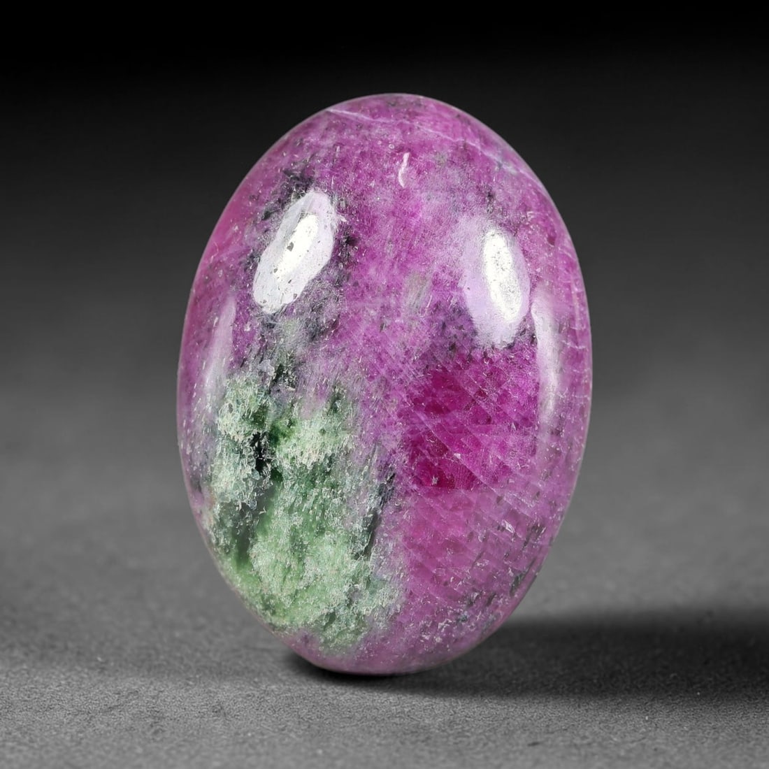 30.25ct Natural Ruby Zoisite Cabochon Loose Gemstone, 20TY: Natural ruby zoisite cabochon cut, dimensions 26.7x19.1x5.8mm. Rich magenta and deep purple swirling colour pattern with natural mineral veining across the polished surface. Smooth polished cabochon f