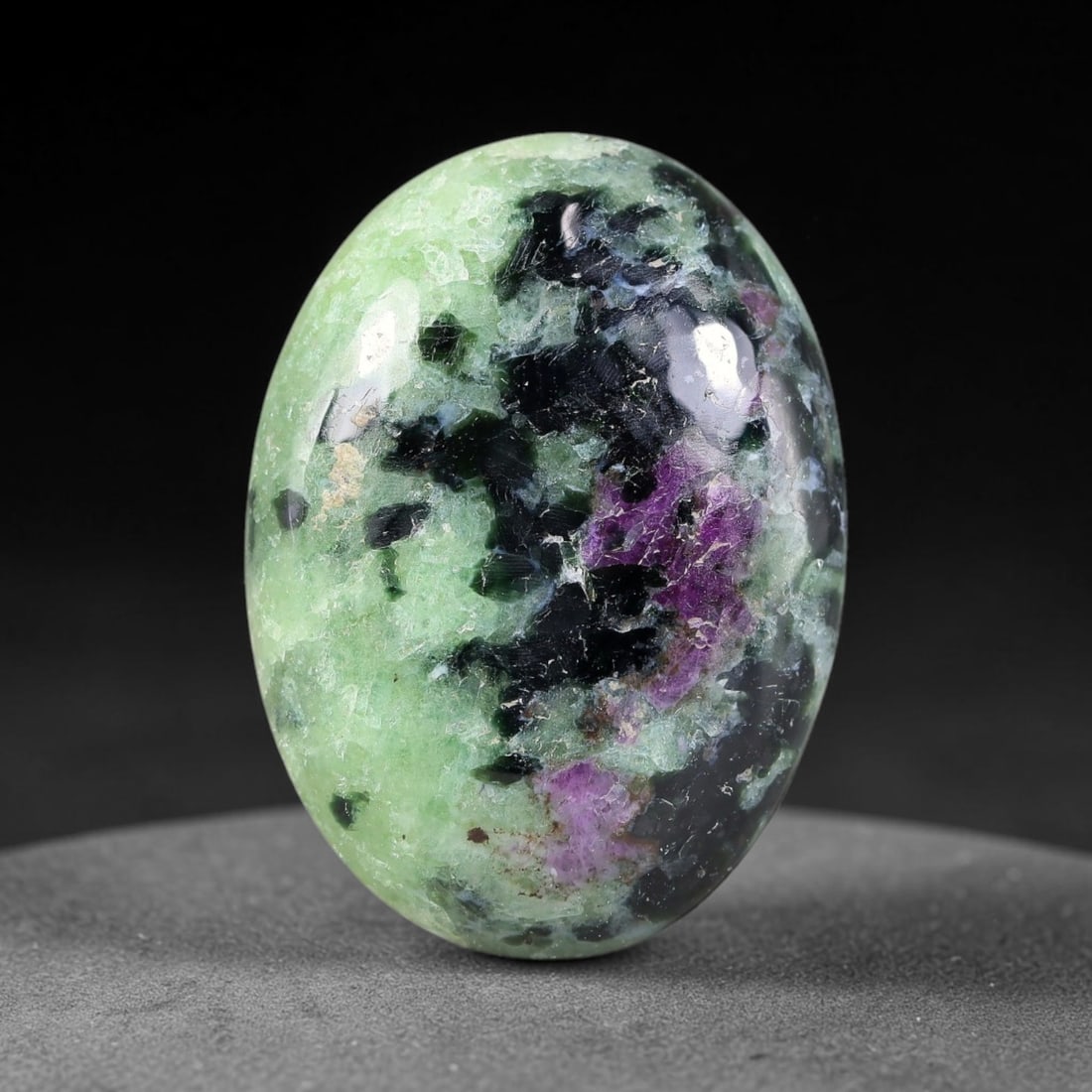 22.87ct Natural Ruby Zoisite Cabochon Loose Gemstone, 25TY: Natural ruby zoisite cabochon cut, dimensions 25.8x19.3x4.9mm. Rich magenta and deep purple swirling colour pattern with natural mineral veining across the polished surface. Smooth polished cabochon f