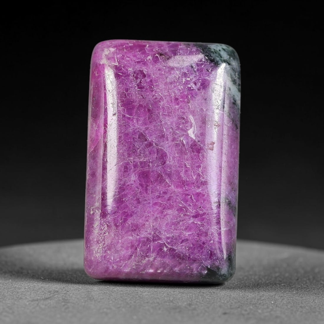 23.46ct Natural Ruby Zoisite Cabochon Loose Gemstone, 2TY: Natural ruby zoisite cabochon cut, dimensions 21.3x13.5x5.4mm. Rich magenta and deep purple swirling colour pattern with natural mineral veining across the polished surface. Smooth polished cabochon f