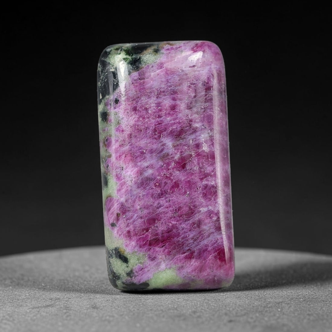 29.58ct Natural Ruby Zoisite Cabochon Loose Gemstone, 91TZ: Natural ruby zoisite cabochon cut, dimensions 27.4x14.4x5.3mm. Rich magenta and deep purple swirling colour pattern with natural mineral veining across the polished surface. Smooth polished cabochon f