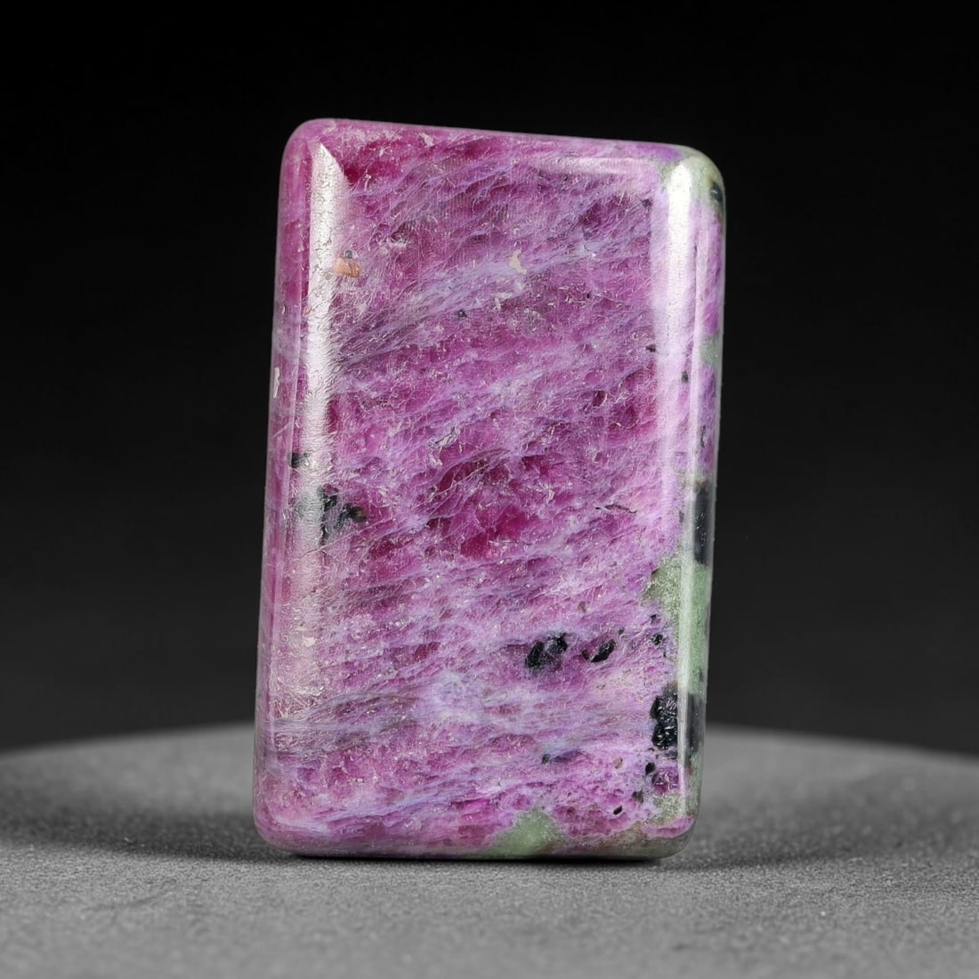 30.15ct Natural Ruby Zoisite Cabochon Loose Gemstone, 8TY: Natural ruby zoisite cabochon cut, dimensions 26.3x16.0x4.6mm. Rich magenta and deep purple swirling colour pattern with natural mineral veining across the polished surface. Smooth polished cabochon f