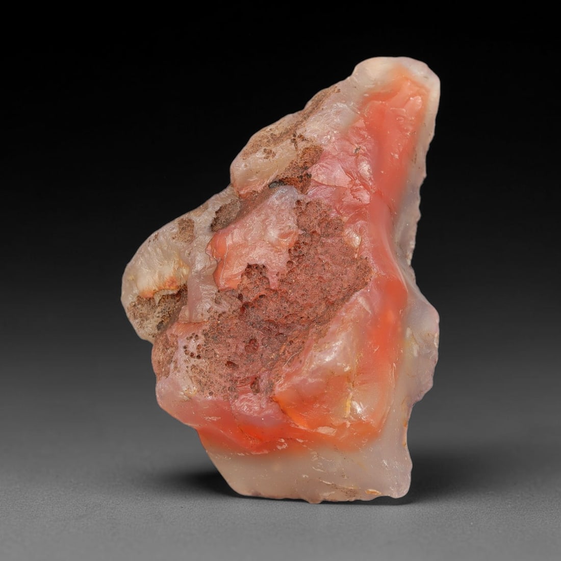 91g Natural Orange Pink Agate Rough Loose Raw Gemstone Specimen, 32SB: This natural orange pink agate rough weighs 91g, measuring 65.7x41.5x31.5mm. It displays striking vibrant orange-pink translucent agate with milky quartz sections and porous brown mineral matrix inclu