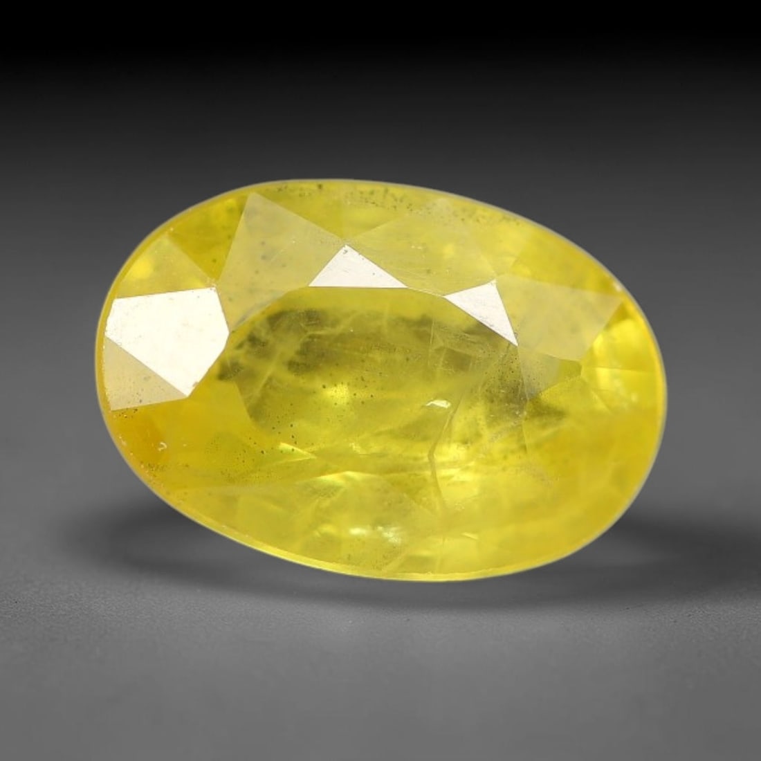 1.13 Carats Natural Yellow Sapphire Oval Faceted Loose Gemstone, 72TT: This natural yellow sapphire features a classic oval brilliant faceted cut, holding consistent warm golden-yellow color throughout the corundum crystal. Fine microscopic mineral specks and faint natur