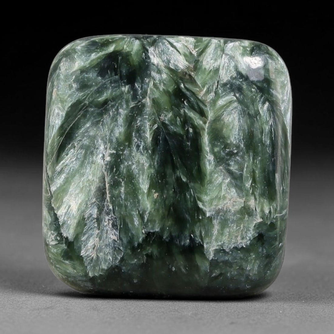 15.32 Carats Natural Deep Green Siberian Seraphinite Polished Cabochon, 82TZ: This is a fully natural polished seraphinite specimen sourced from Siberian deposits, displaying distinct feathery fibrous inclusions that create beautiful flowing chatoyant patterns across its smooth