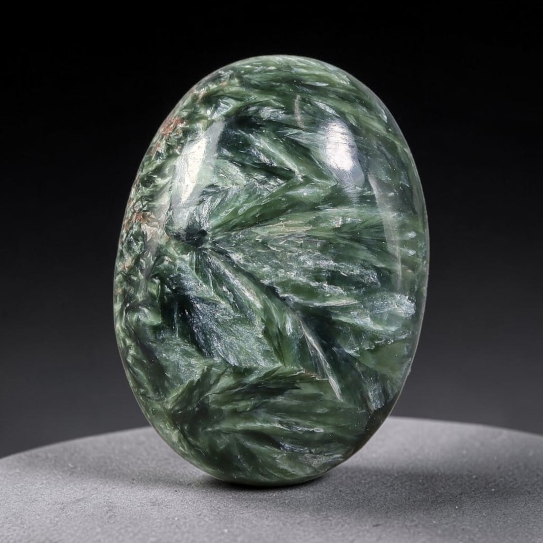 15.15 Carats Natural Deep Green Siberian Seraphinite Polished Cabochon, 56TZ: This is a fully natural polished seraphinite specimen sourced from Siberian deposits, displaying distinct feathery fibrous inclusions that create beautiful flowing chatoyant patterns across its smooth