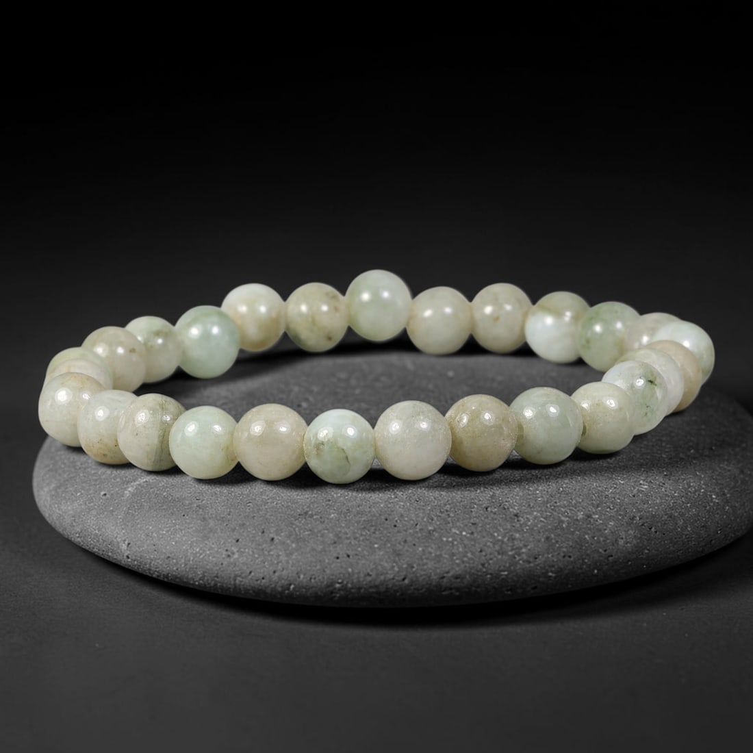 Natural Burmese Type A Pale Celadon Jadeite Jade Bracelet, 67TK: Hand-strung bracelet crafted from polished round natural Burmese Type A jadeite beads measuring 7.8mm. The beads feature soft pale celadon and milky off-white tones with subtle natural beige inclusion