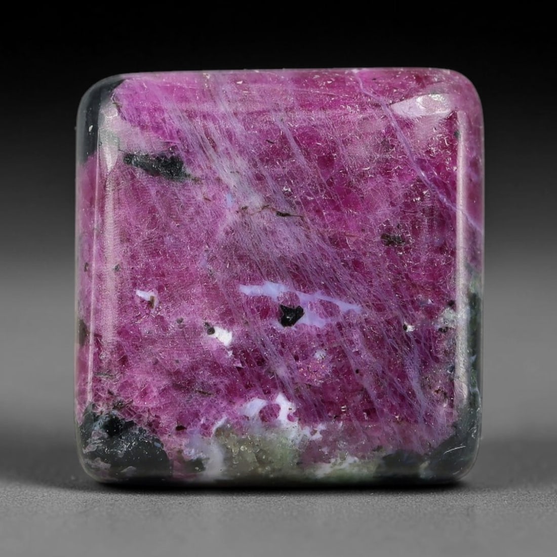 25.72ct Natural Ruby Zoisite Cabochon Loose Gemstone, 90TZ: Natural ruby zoisite cabochon cut, dimensions 17.2x16.9x5.8mm. Rich magenta and deep purple swirling colour pattern with natural mineral veining across the polished surface. Smooth polished cabochon f