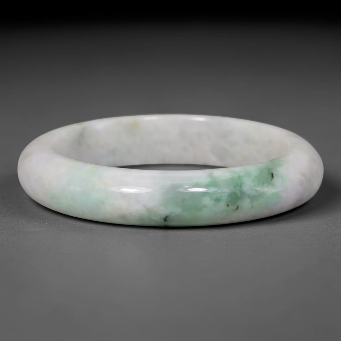 Natural Burmese Type A Pale White Floating Green Jadeite Jade Bangle Bracelet, 22TD: This thick band bangle is crafted from natural Burmese Type A jadeite. The stone features a creamy pale white base with soft clouded patches of light floating green concentrated on one side of the ban